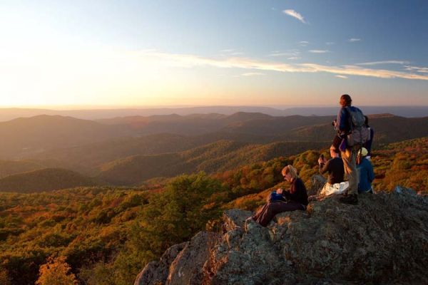 friends out in mountains at sunset