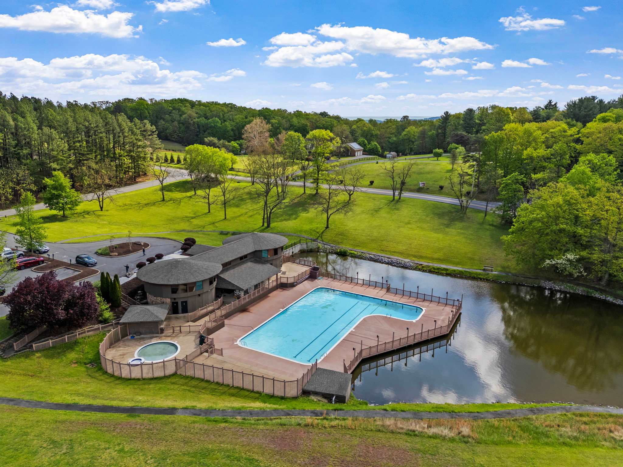 Aerial view of the outdoor pool and lake at The Woods Resort