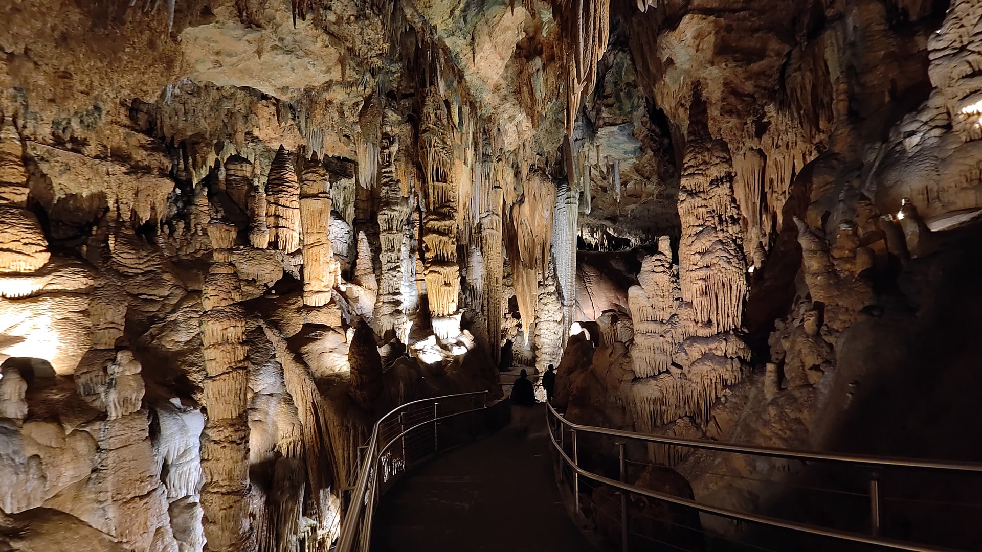 Lighted walkway between stalactites and columns inside Luray Caverns in Luray, Virginia