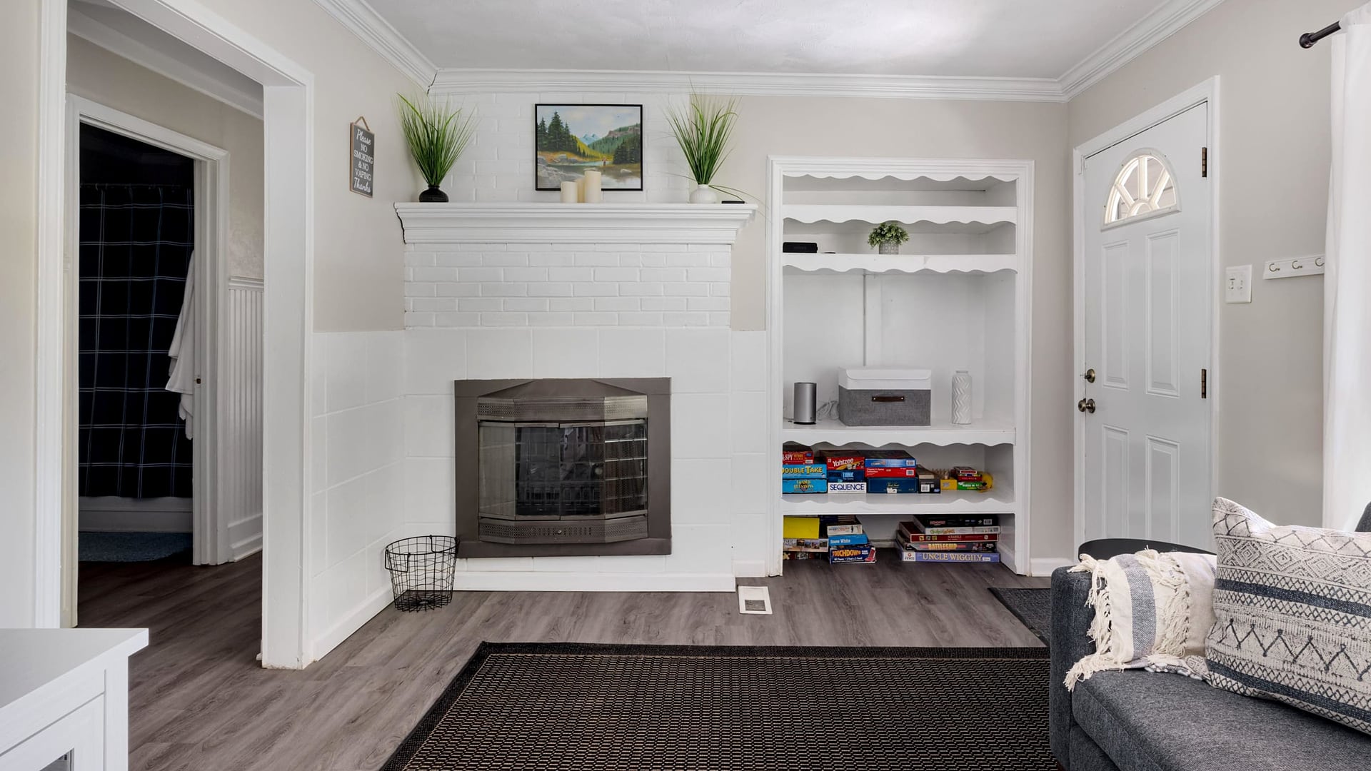 Fireplace and game shelves in the living room at Nature's Nook, a Blue Maple cabin near Luray, Virginia