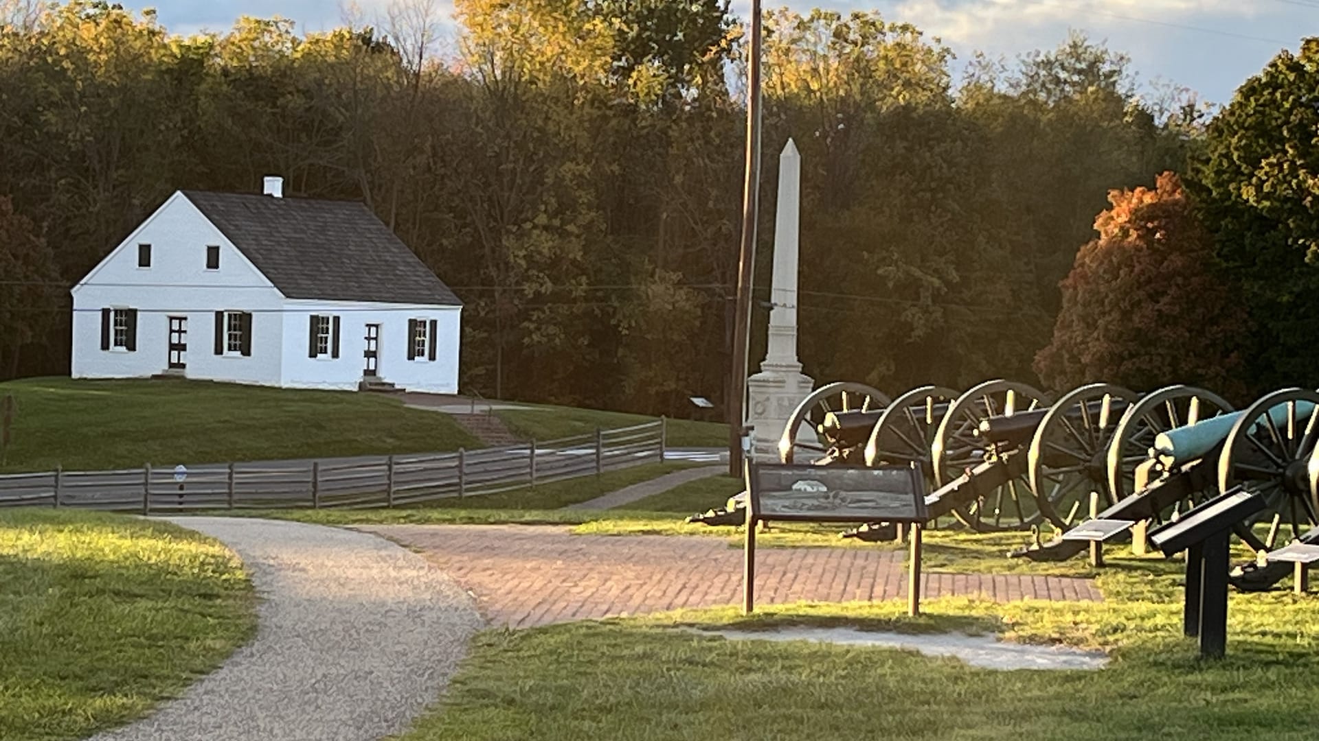 The white Dunker Church and cannon at Antietam National Battlefield in autumn light