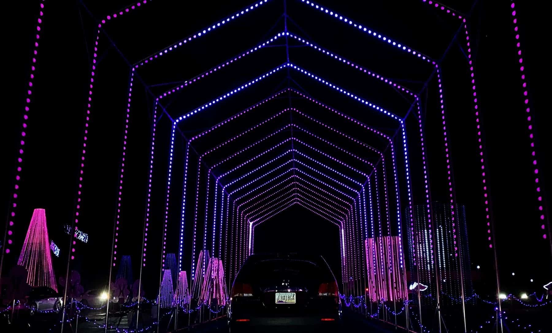 Drive-through tunnel of holiday lights at night