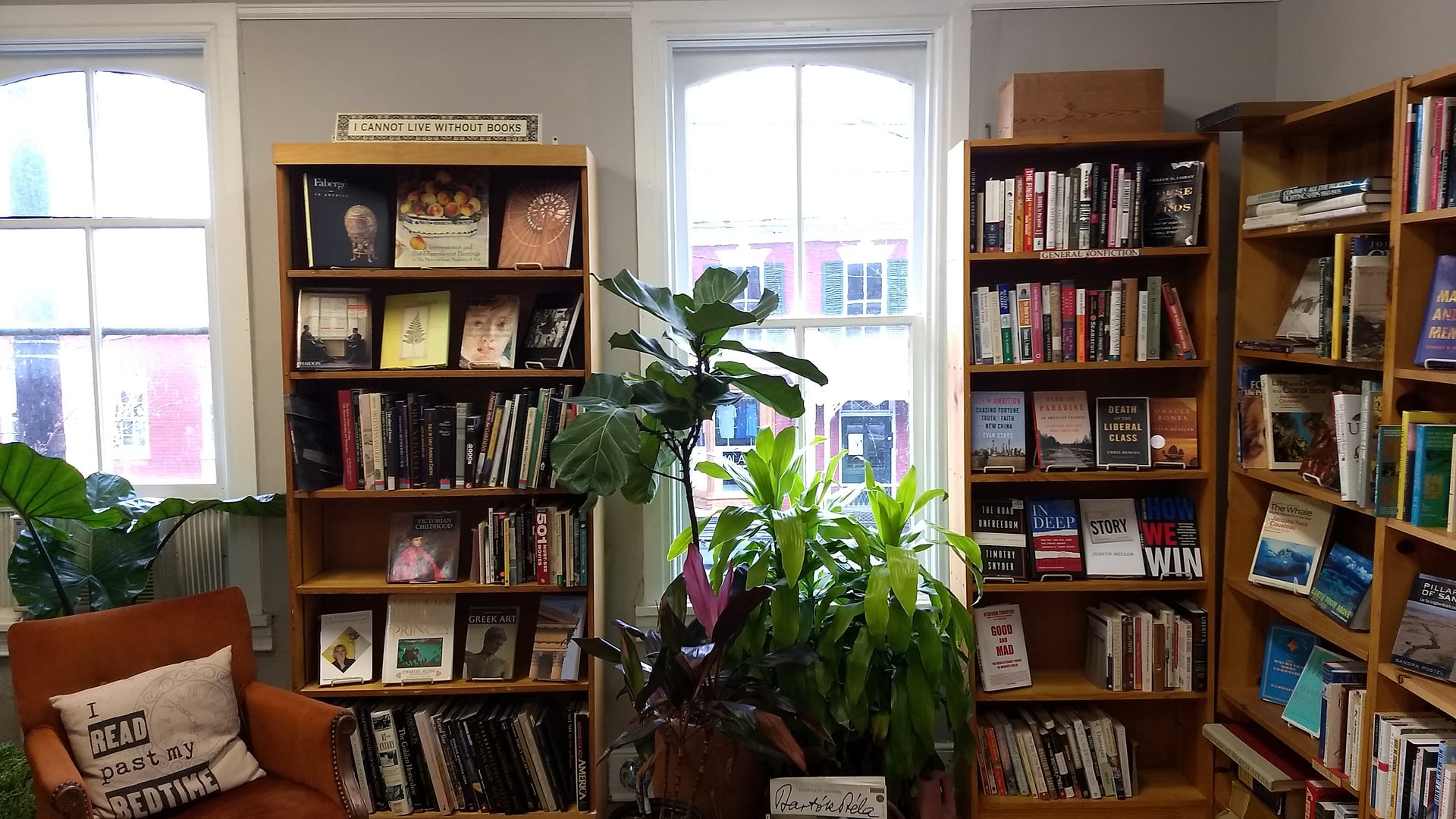 Bookshelves and a reading chair inside Four Seasons Books in Shepherdstown