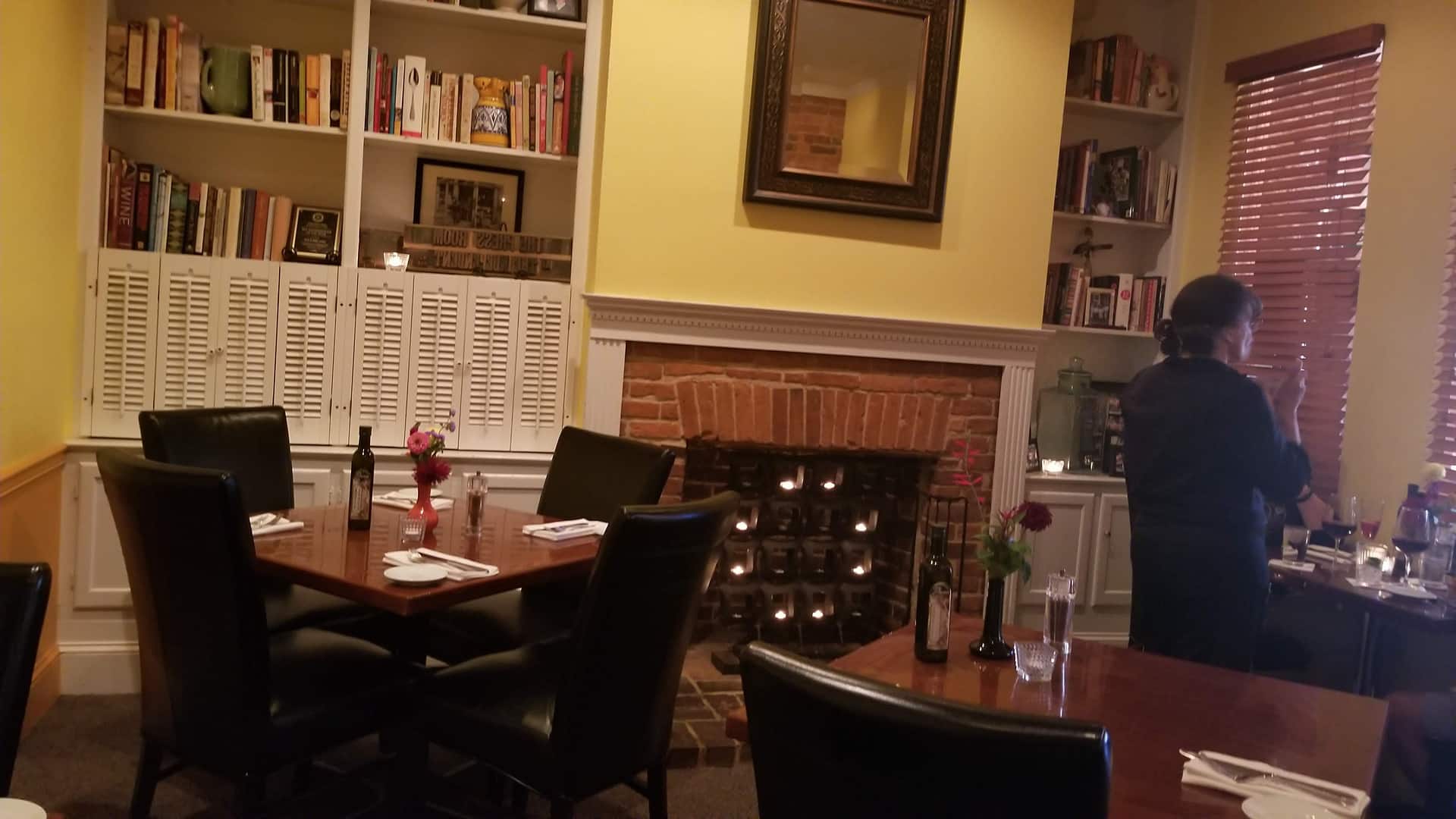 A fireside table by the bookshelves inside the Press Room restaurant in Shepherdstown